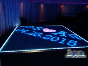 LED dance floor with custom monogram displayed